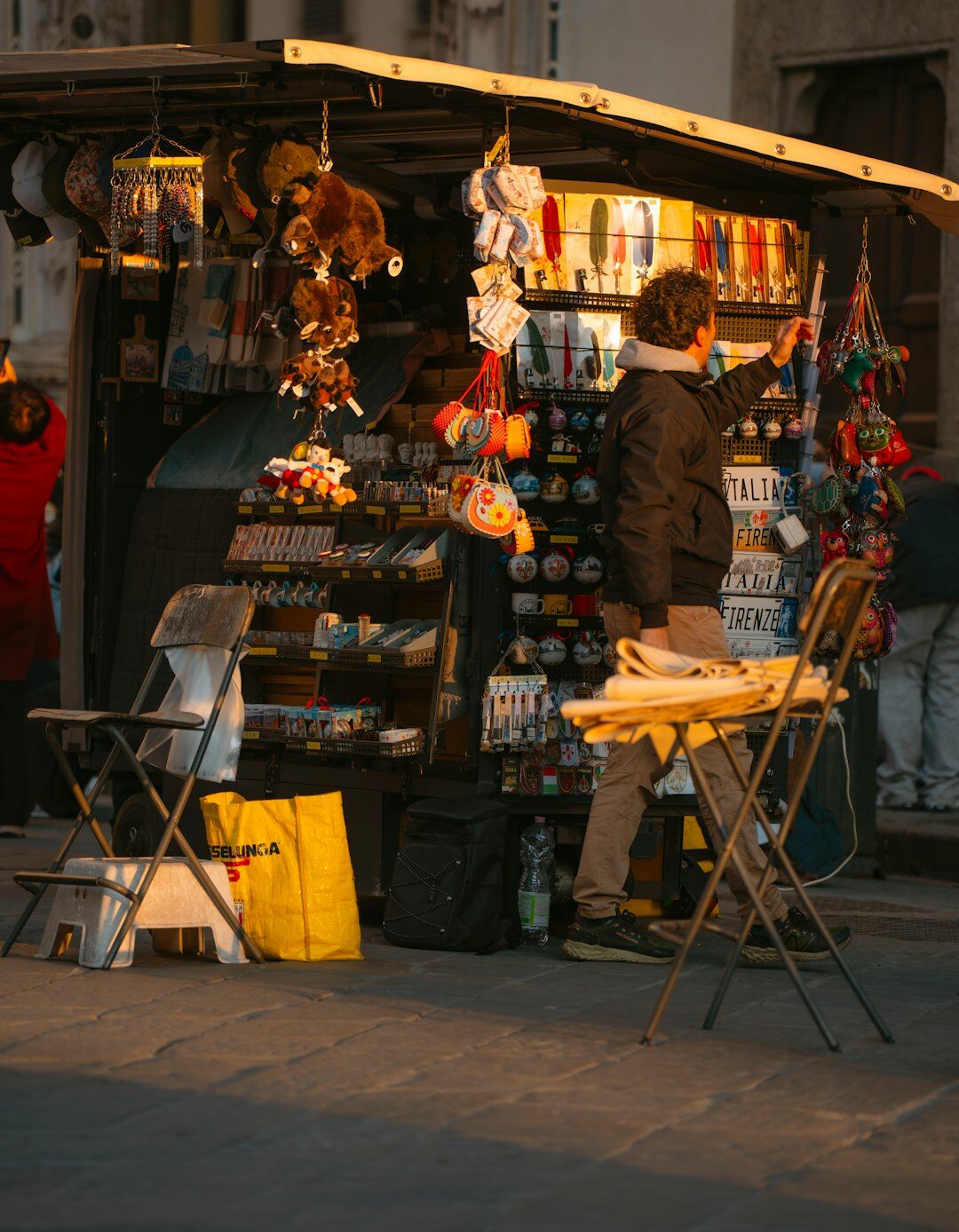 woman selling flowers at street stand